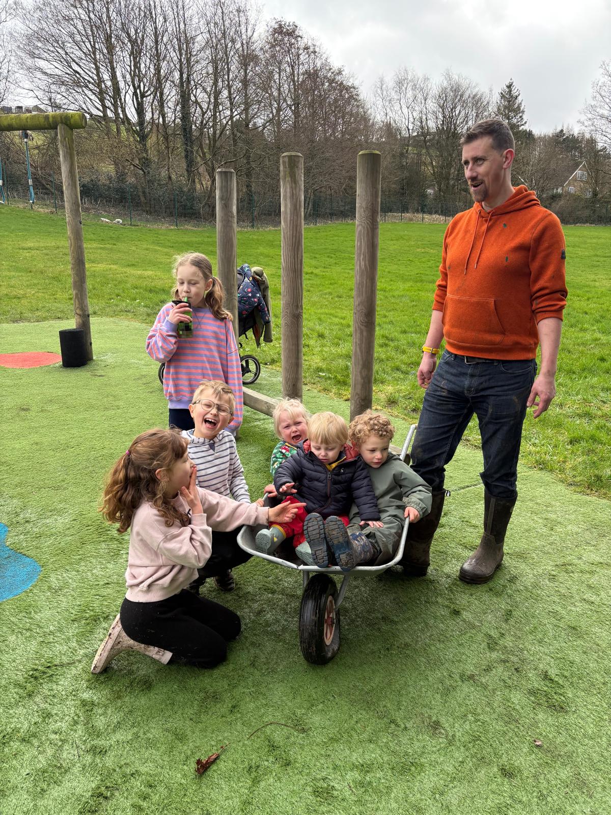 Volunteers and families with a wheelbarrow